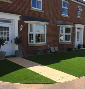 Adjoining front gardens in Cullompton, both shown with new artificial lawns