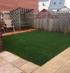 Artificial grass area fit for a family's newly built modern home
