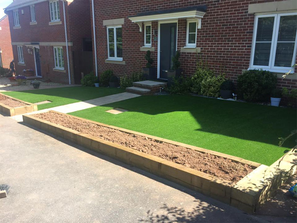 Freshly laid lawn and newly constructed raised beds