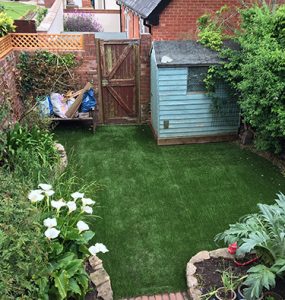 Cut to fit curved artificial grass within a walled garden