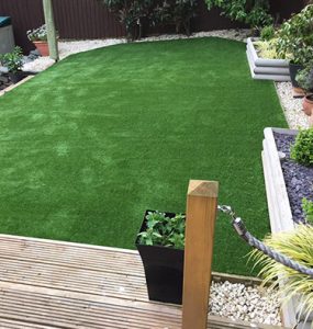 Artificially grassed area created to complement modern decking space