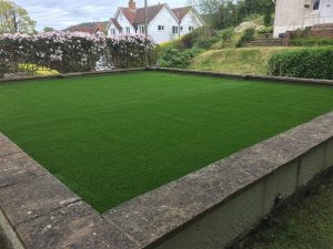 Close up of artificial grass in a raised front garden in Sidmouth